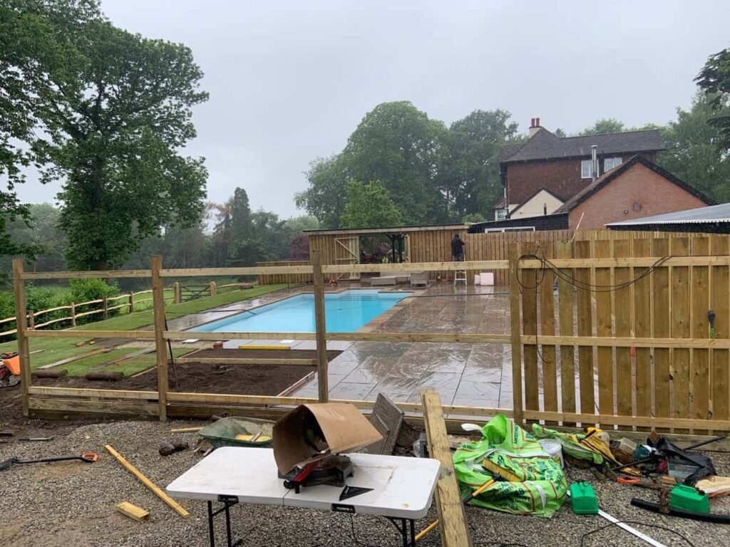 This is a photo of Bespoke custom fencing installed around a swimming pool by Fast Fix Fencing Tunbridge Wells
